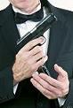 man with dinner jacket and gun