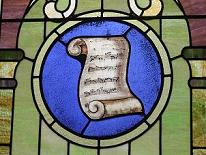 stained glass window with scroll of sheet music notation